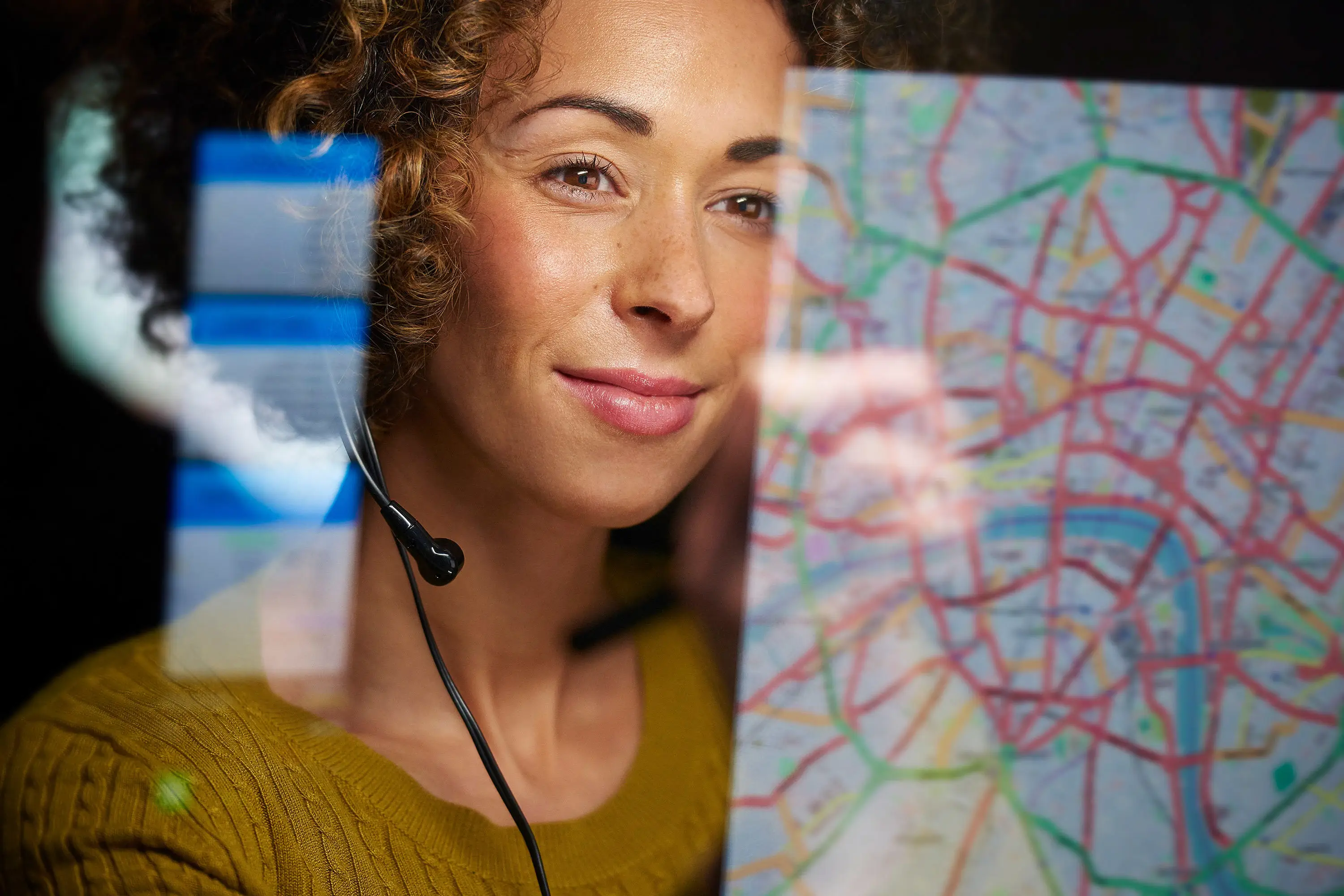 Women looking at map on computer screen