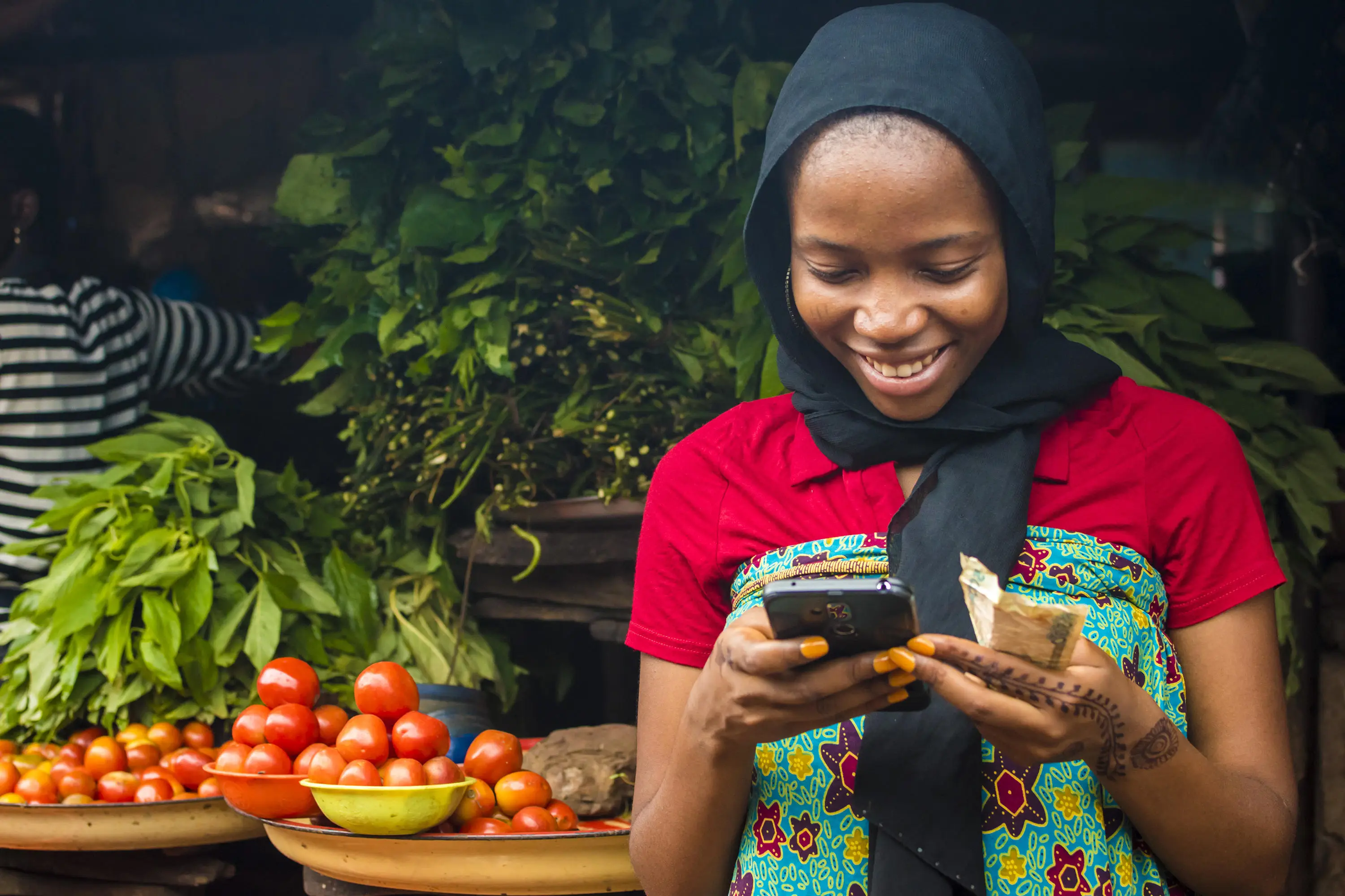 Girl using phone at market