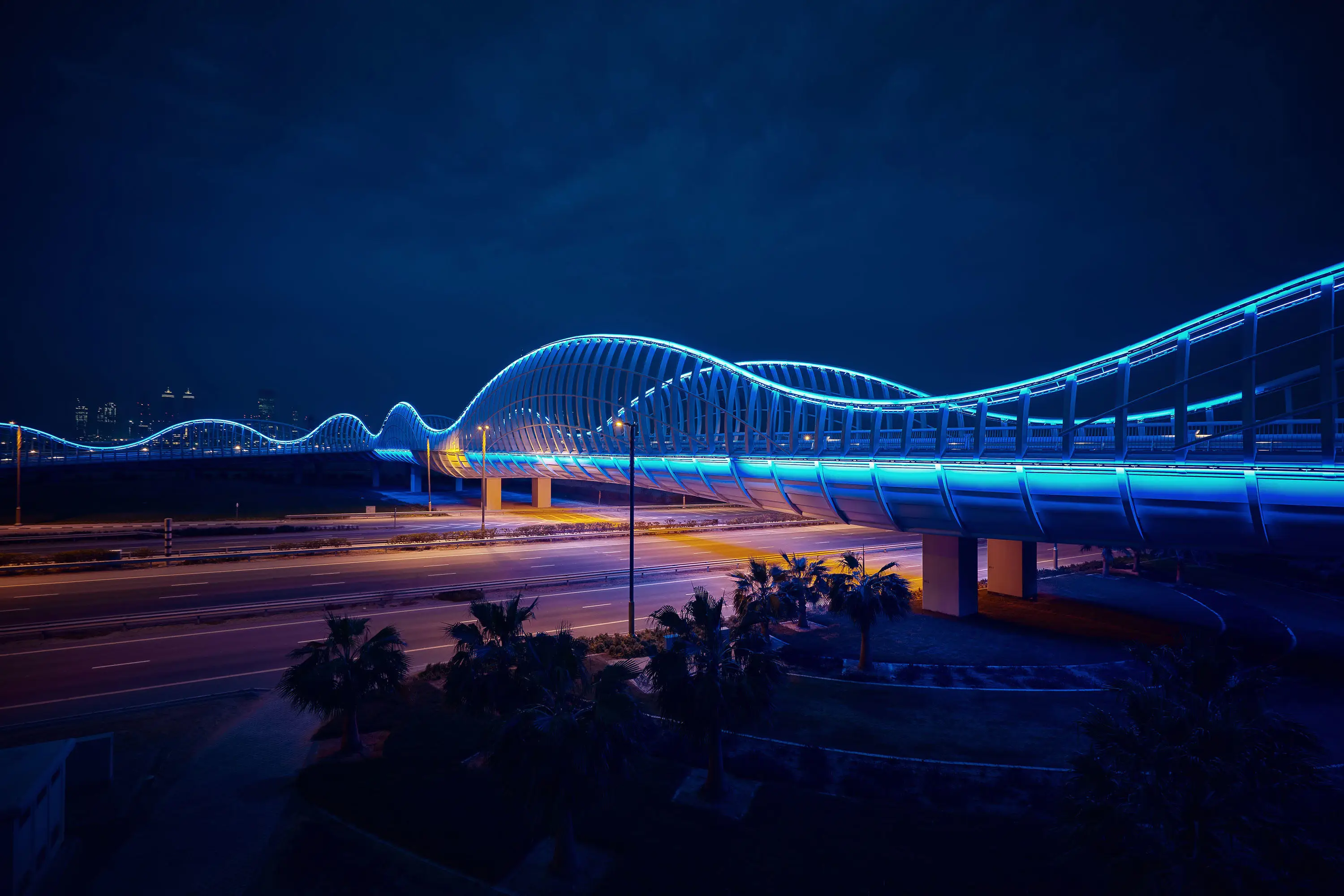 Bridge lit up at night in Dubai