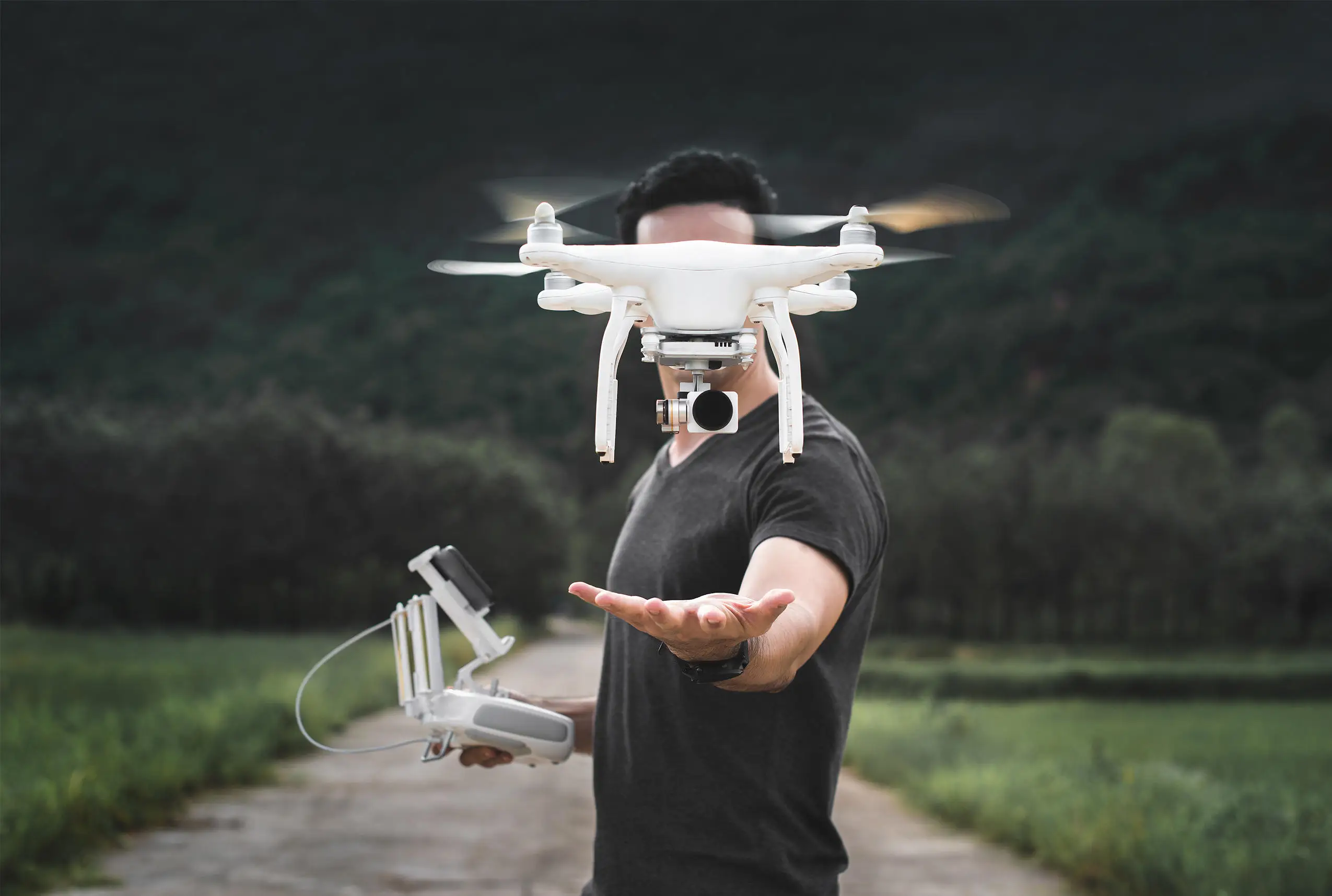 Drone taking off in front of man