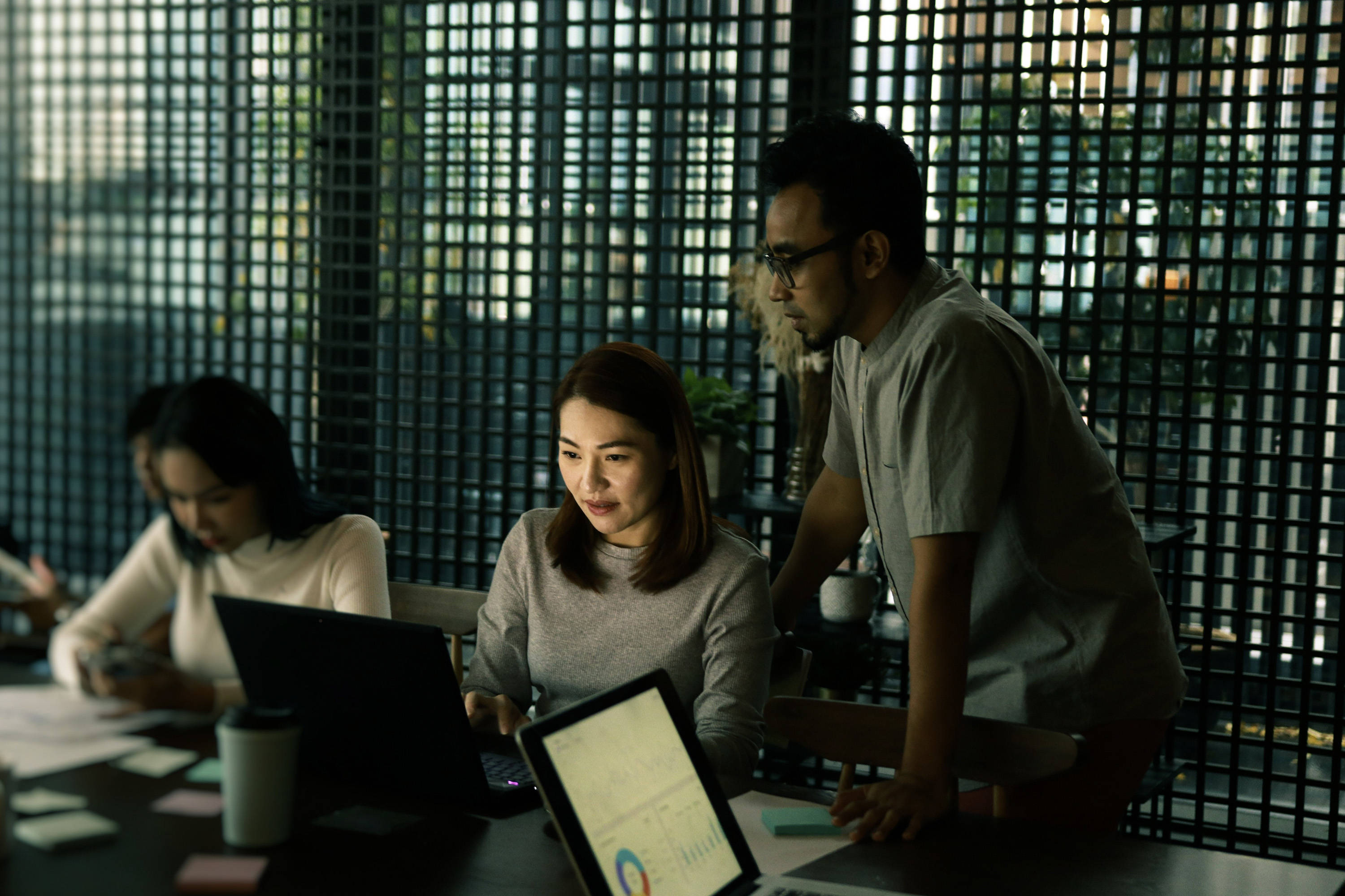 Office with people looking at laptops