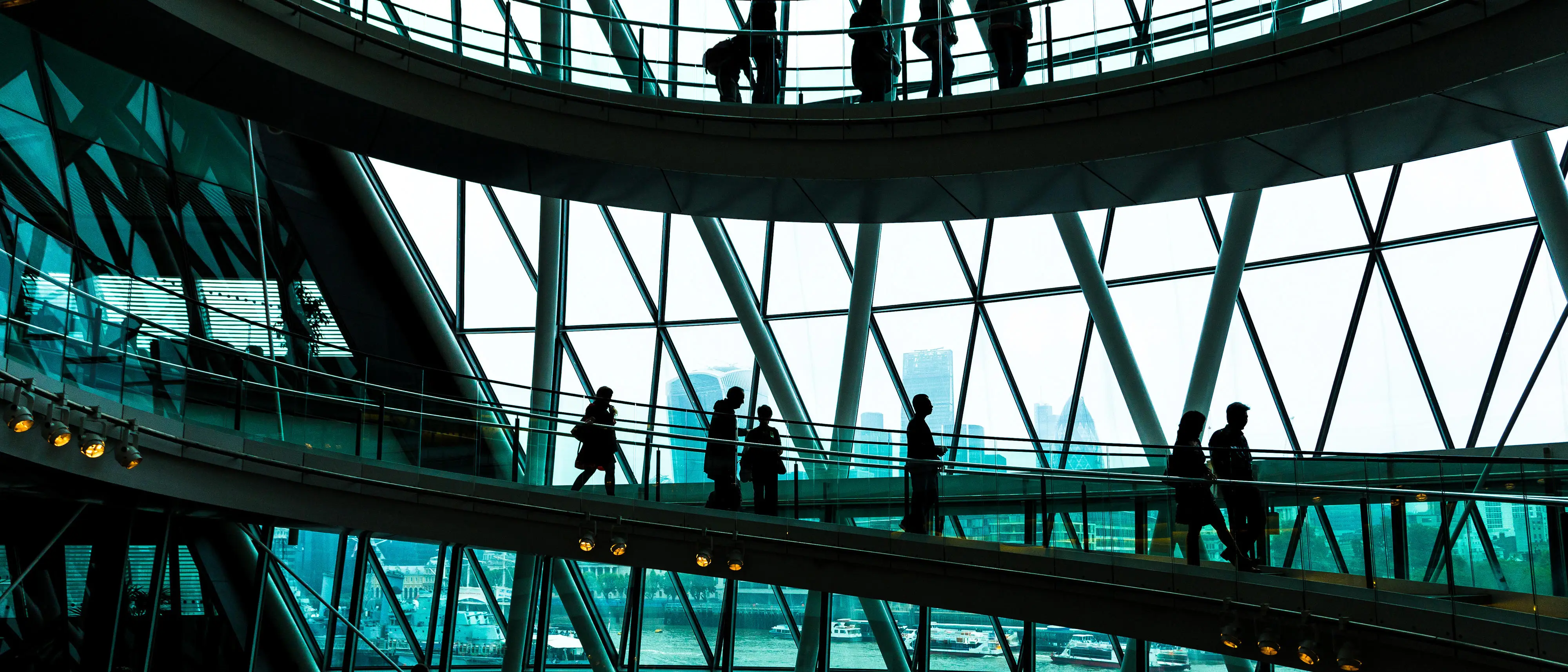 Silhoutte image of people inside high rise building in London
