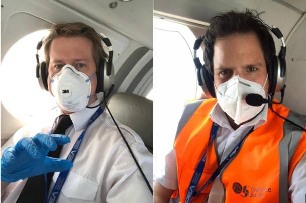 Air Camera Operators Roger and Stefan pose in the plane with their masks on