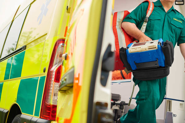 Paramedic coming out of an ambulance