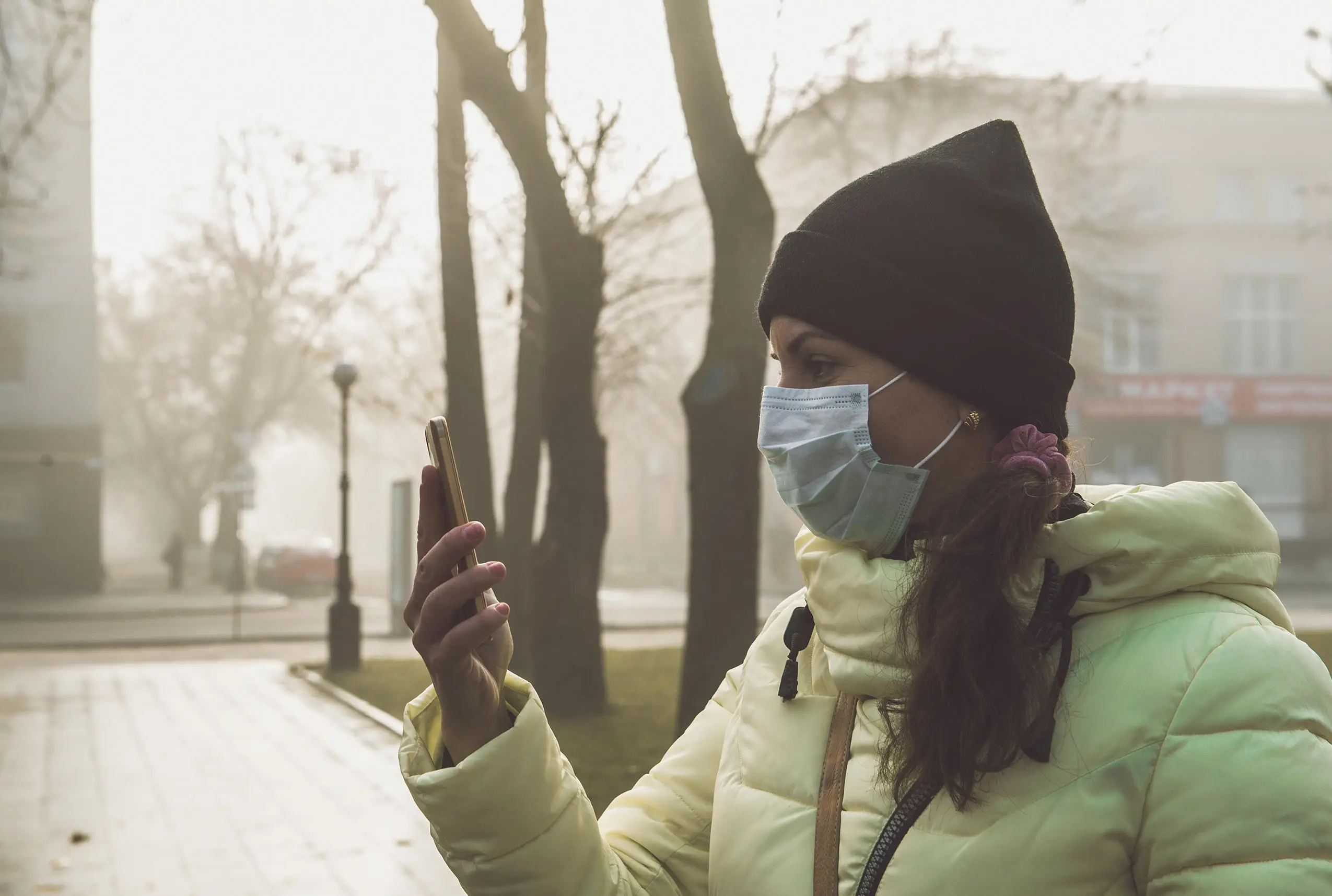 Woman with a face mask in smog