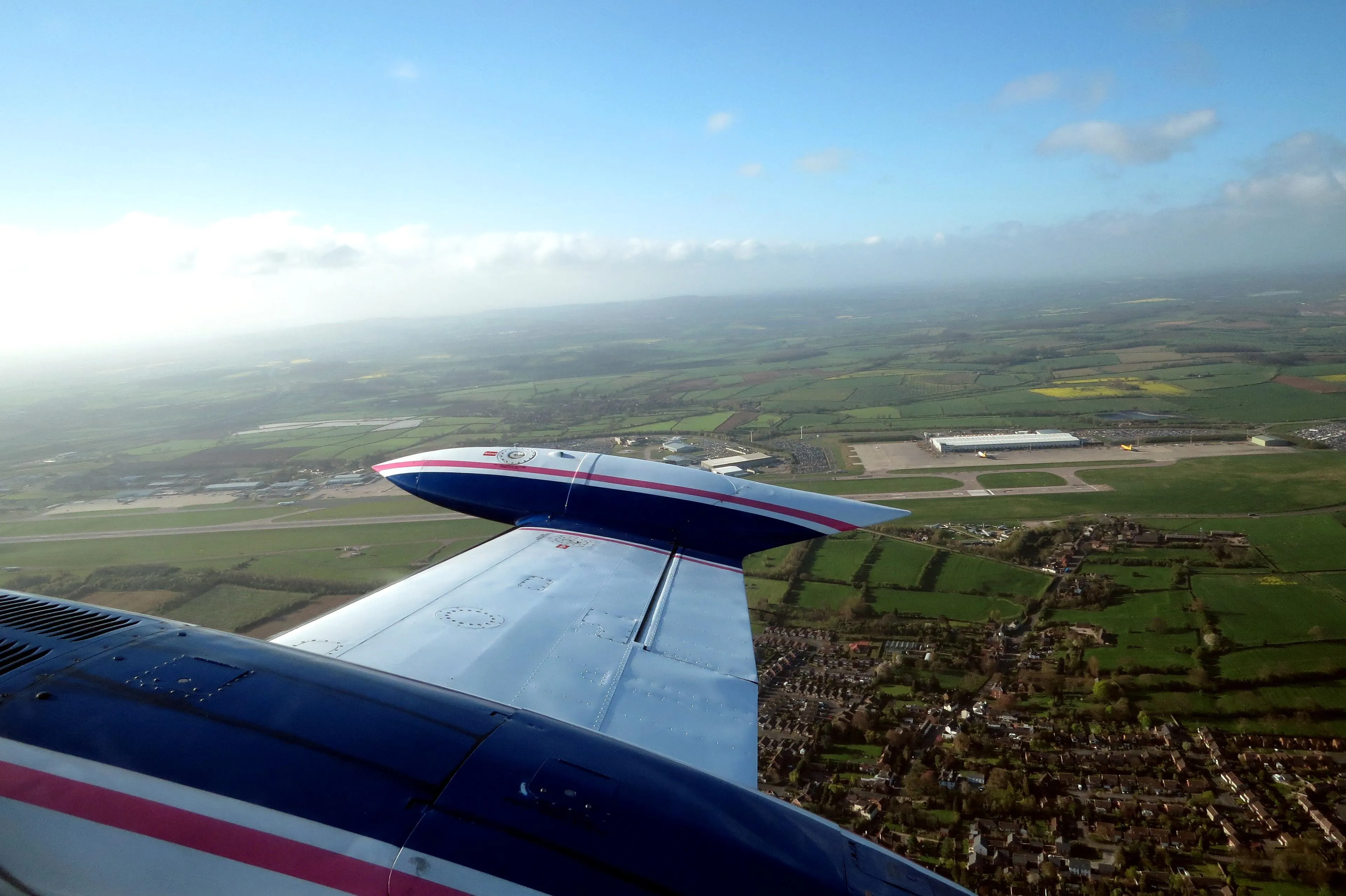 A plane wing over East Midlands Airport