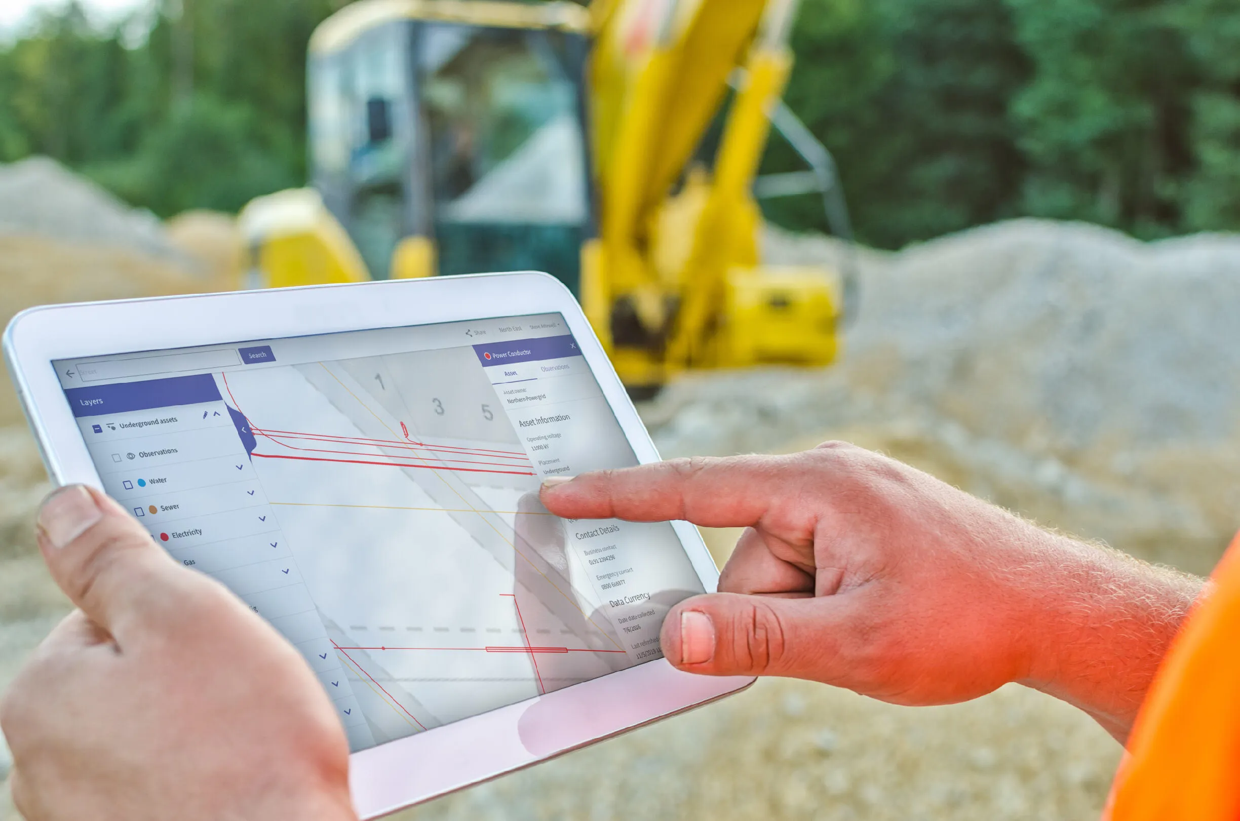 A construction worker using NUAR on a tablet device to identify electricity cables underground