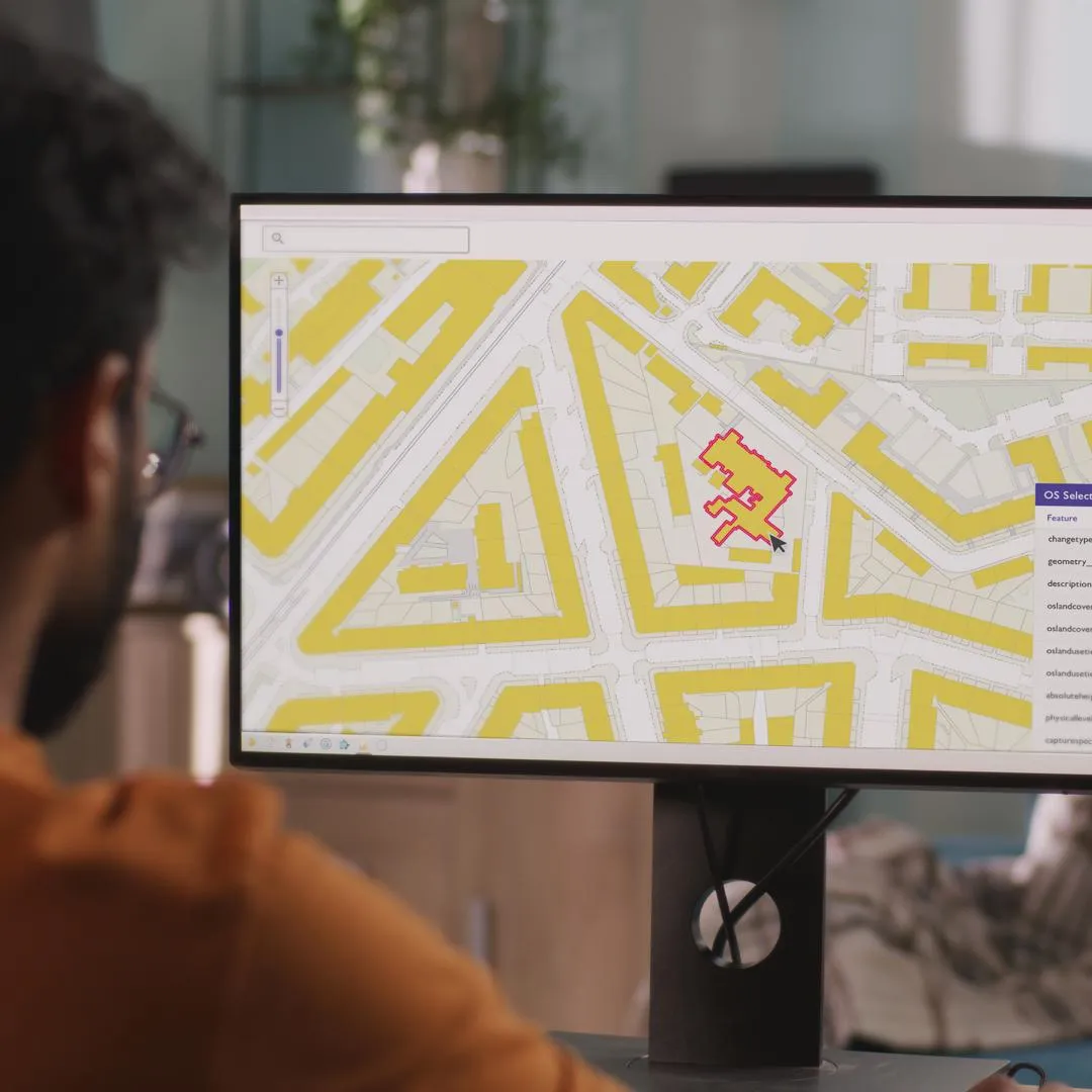Person at a computer using OS NGD Select+Build, creating a customised data selection.
