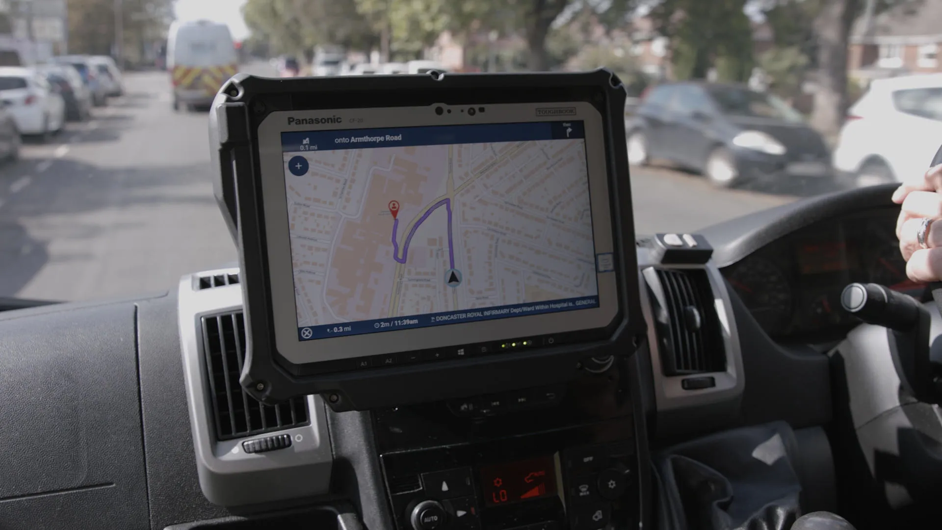 Tablet mounted in vehicle shows a map with a route marked from vehicle location to destination