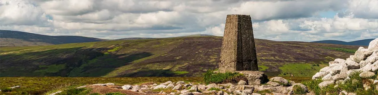 A trig pillar on top of a hill