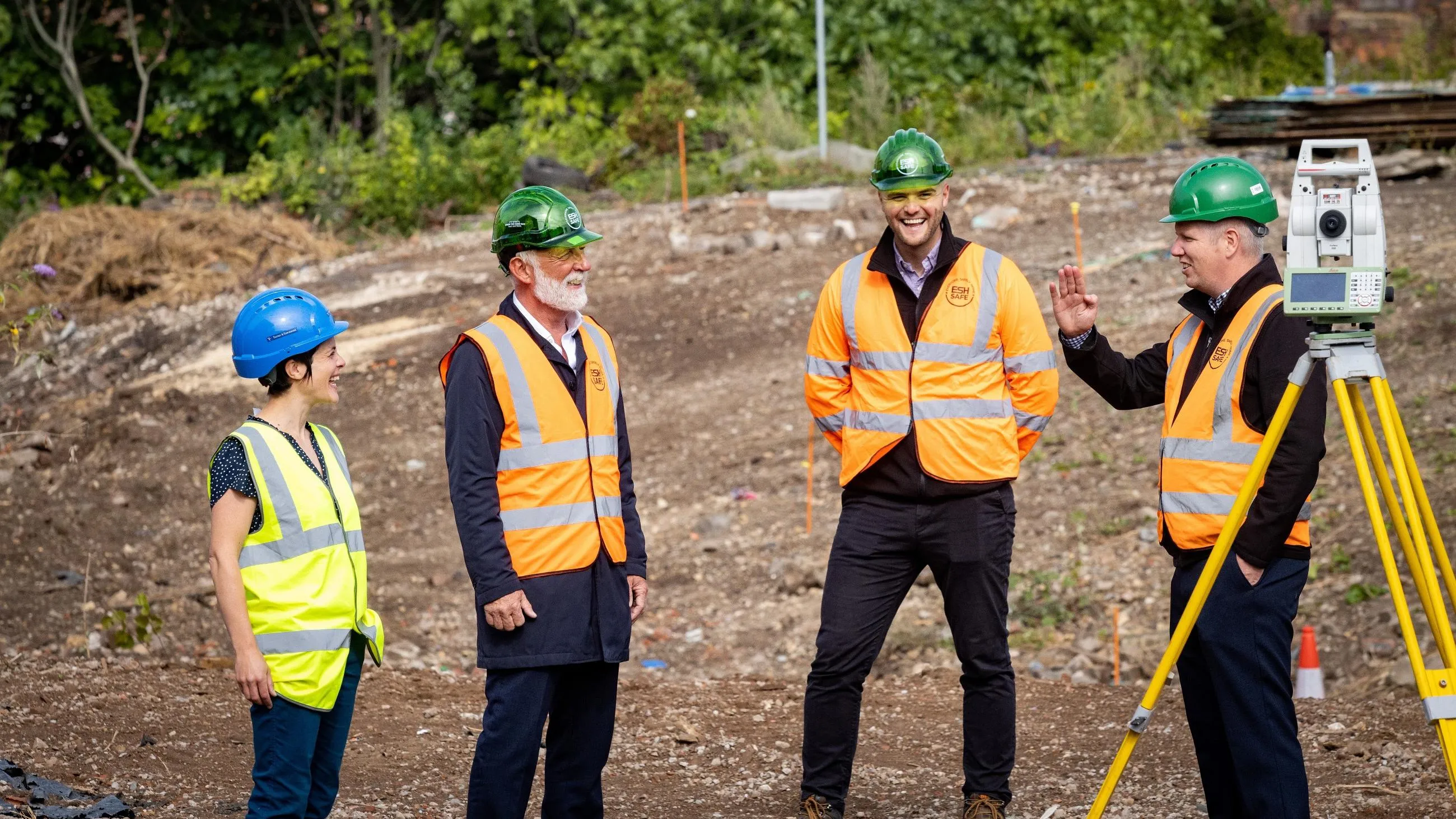 Four colleagues in high-vis standing in a construction site